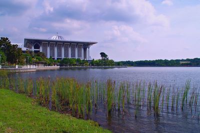 Scenic view of lake by building against sky