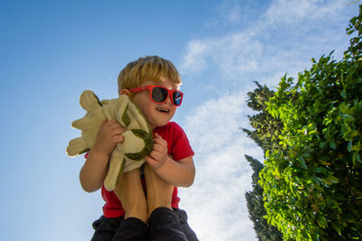 Low section of man playing son against sky