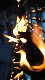 Close-up of lit candles at night