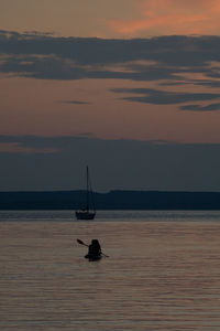 Silhouette sailboat on sea against sky during sunset