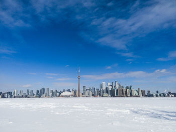 Modern buildings in city against blue sky