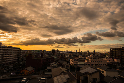 Aerial view of cityscape against storm clouds