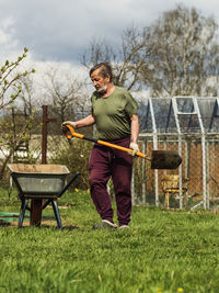 Young man standing on grass in yard