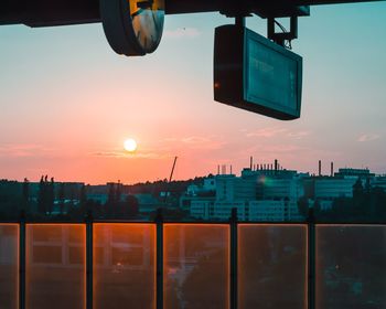 View of illuminated buildings against sky during sunset