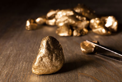 Close-up of golden nuggets on wooden table