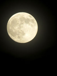 Low angle view of moon against clear sky at night