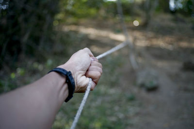 Close-up of hand holding rope