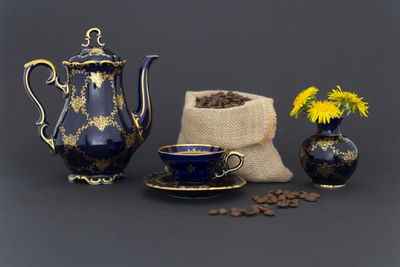 Close-up of tea light on table against black background