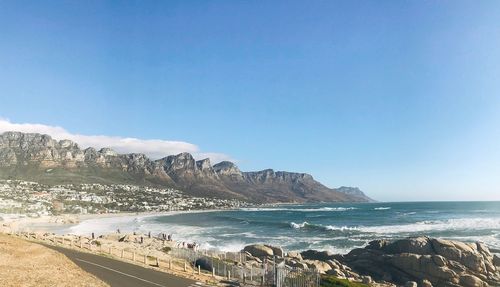 Scenic view of beach against clear blue sky