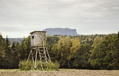 Built structure on field against sky