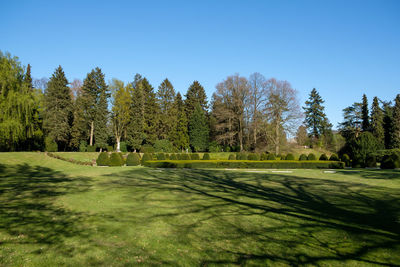 Scenic view of golf course against clear sky