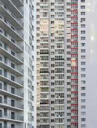 A large number of windows and balconies on building facade. apartment block. residential building