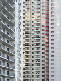 A large number of windows and balconies on building facade. apartment block. residential building