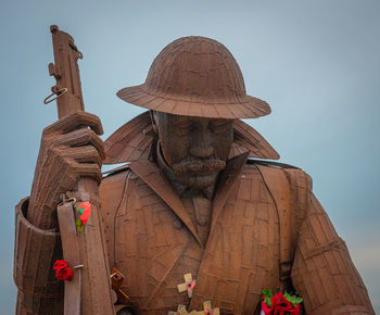 Low angle view of statue against sky