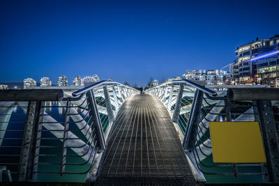 Illuminated bridge against sky at night