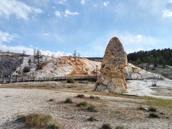 Rocks on landscape against sky