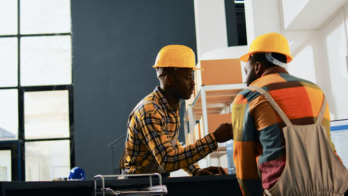 Rear view of man working at construction site