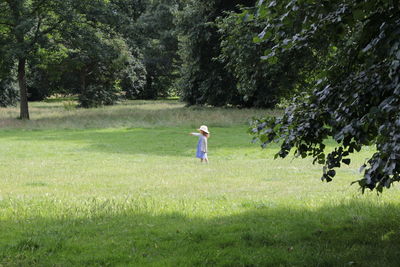 Side view of playing flying over grassy field