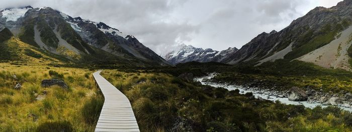 Scenic view of mountains against cloudy sky