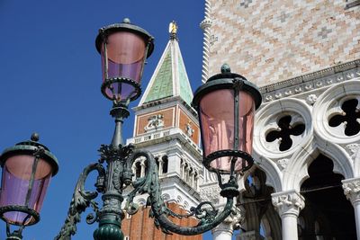 Low angle view of street light against building