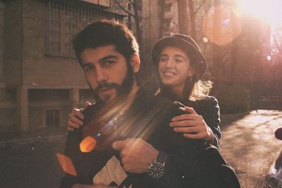 Portrait of young man holding camera