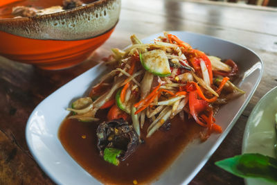 High angle view of som tam salad served in tray on table