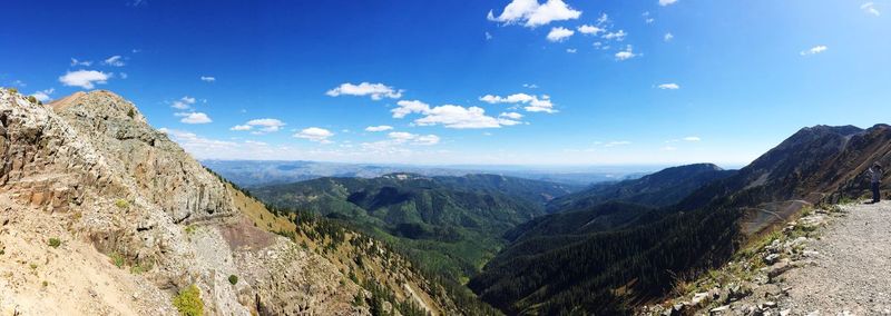 Panoramic view of mountains against blue sky