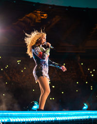 Low angle view of woman standing at night