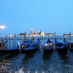Boats in sea against clear sky