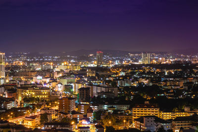 High angle view of illuminated cityscape against sky at night