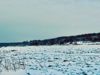 Scenic view of snow covered landscape against sky