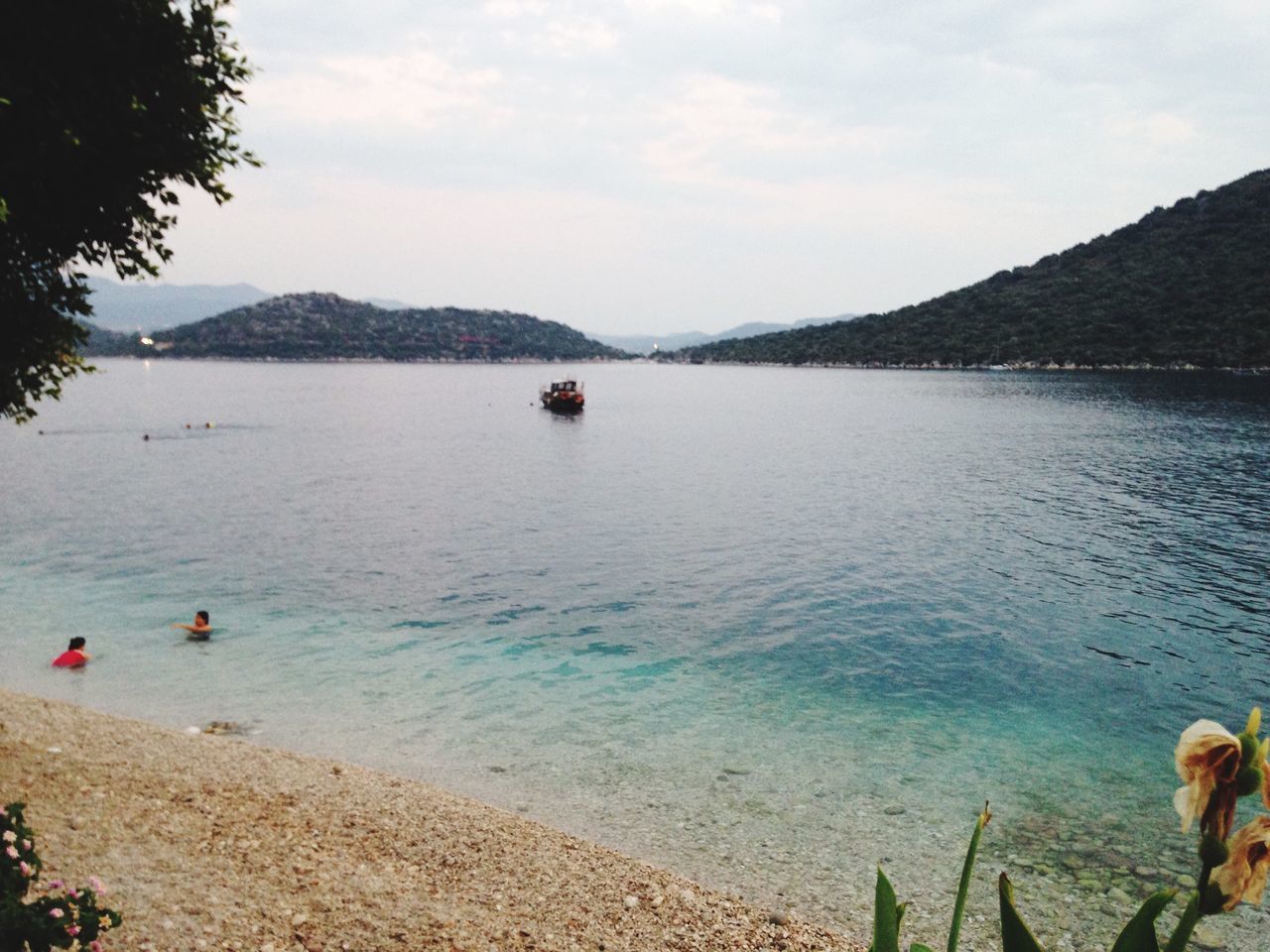 water, mountain, sky, scenics, tranquility, tranquil scene, leisure activity, lifestyles, lake, beauty in nature, nature, men, person, sea, cloud - sky, tree, mountain range, beach, nautical vessel