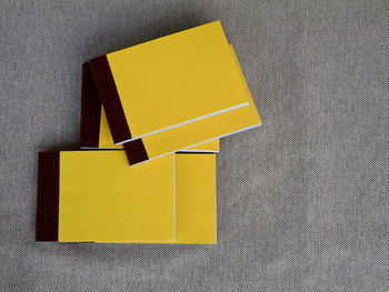 High angle view of yellow paper on table