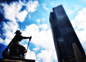 Low angle view of statue against cloudy sky