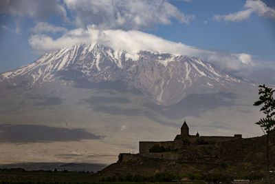 Panoramic view of building and mountains against sky