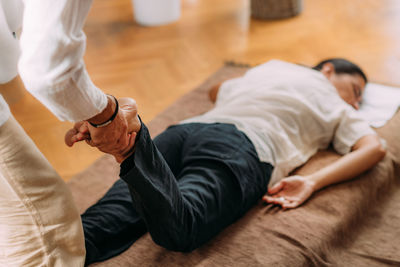 Therapist stretching womans leg. shiatsu massage.