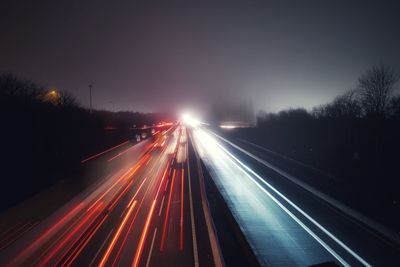 High angle view of light trails on highway at night