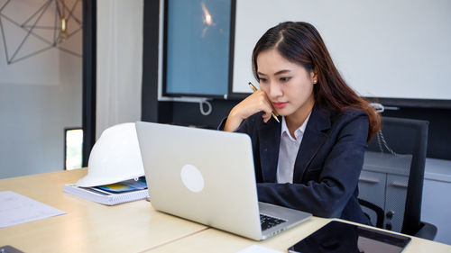 Businesswoman using laptop at office