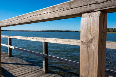 Pier over sea against blue sky