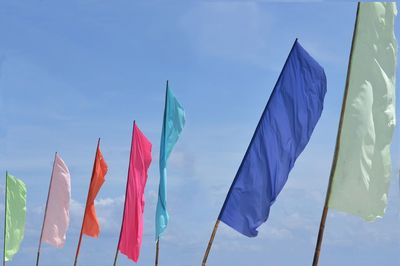 Colorful beach flags against sky