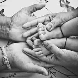 Cropped image of parents holding baby foot