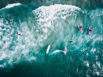 High angle view of people swimming in sea