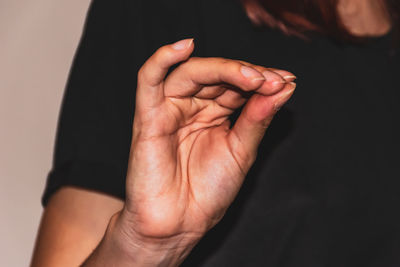 Close-up of man hand over black background