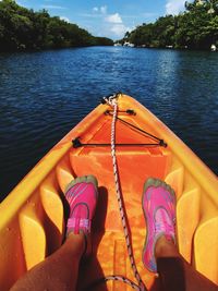 Low section of person on boat in river