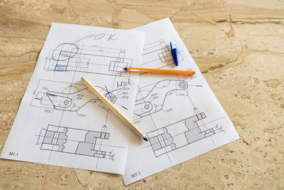 High angle view of blueprint on marble