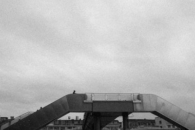 Low angle view of bridge against sky in city