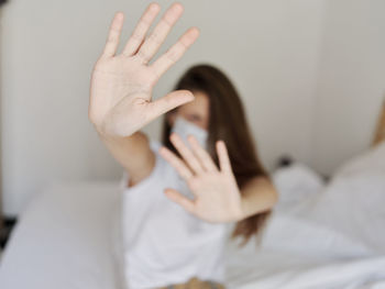 Midsection of woman lying on bed at home