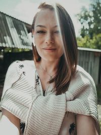 Portrait of smiling woman standing outdoors