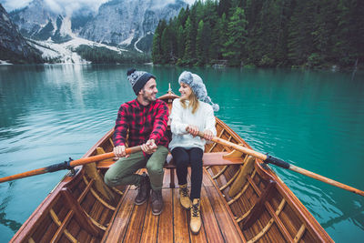 People sitting on boat in lake