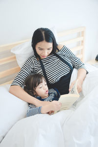 Happy woman lying on bed